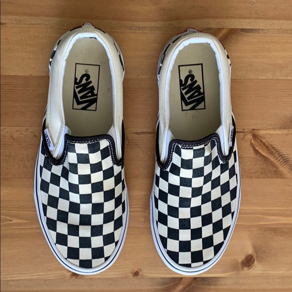 Black and white checkerboard Vans slip-ons